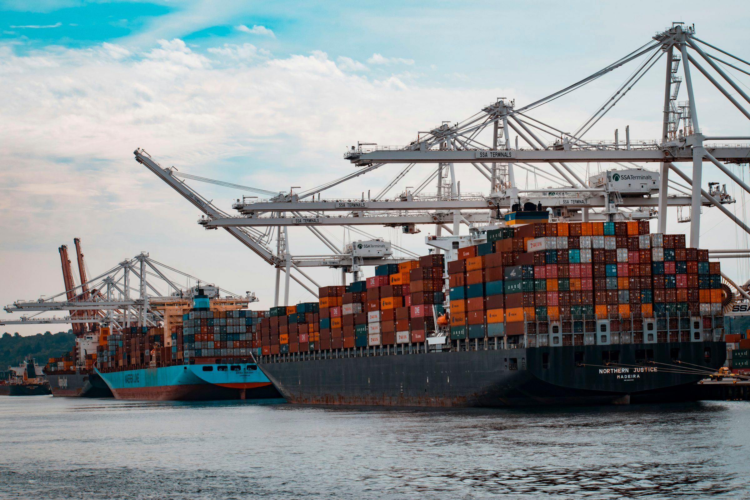 Container ship being loaded at a busy port