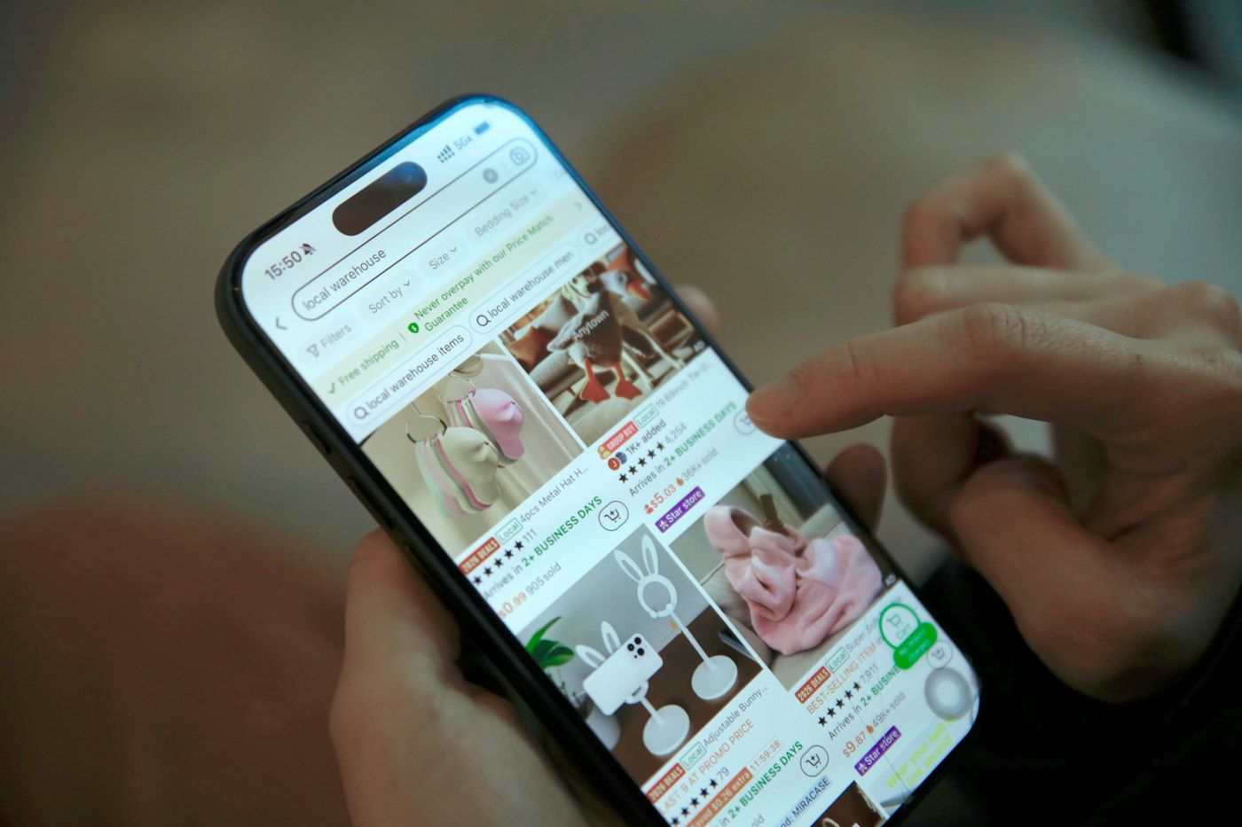 Person browsing an online marketplace on a phone