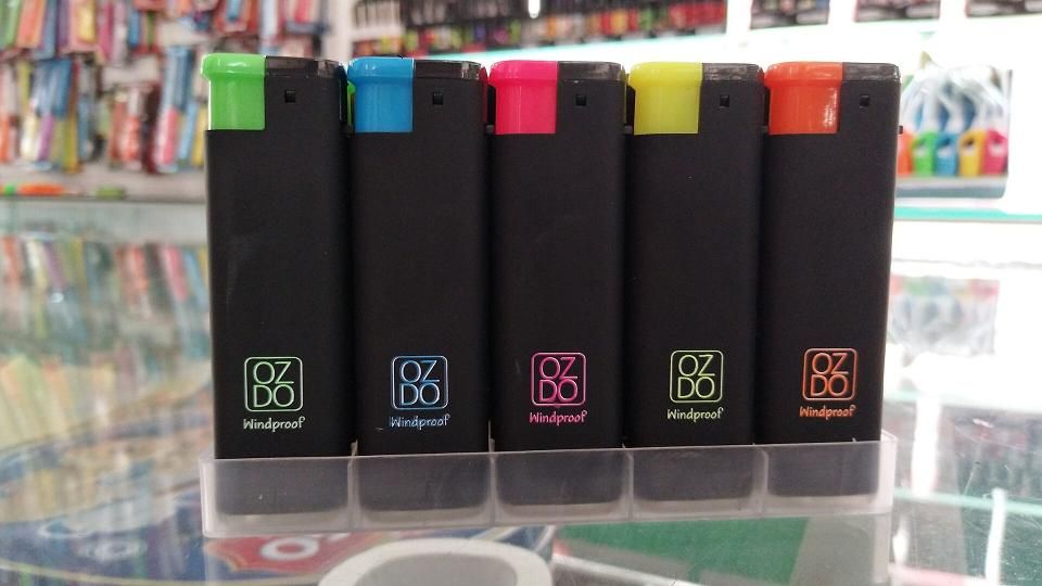 Ozdo windproof lighters with coloured tops in a counter display