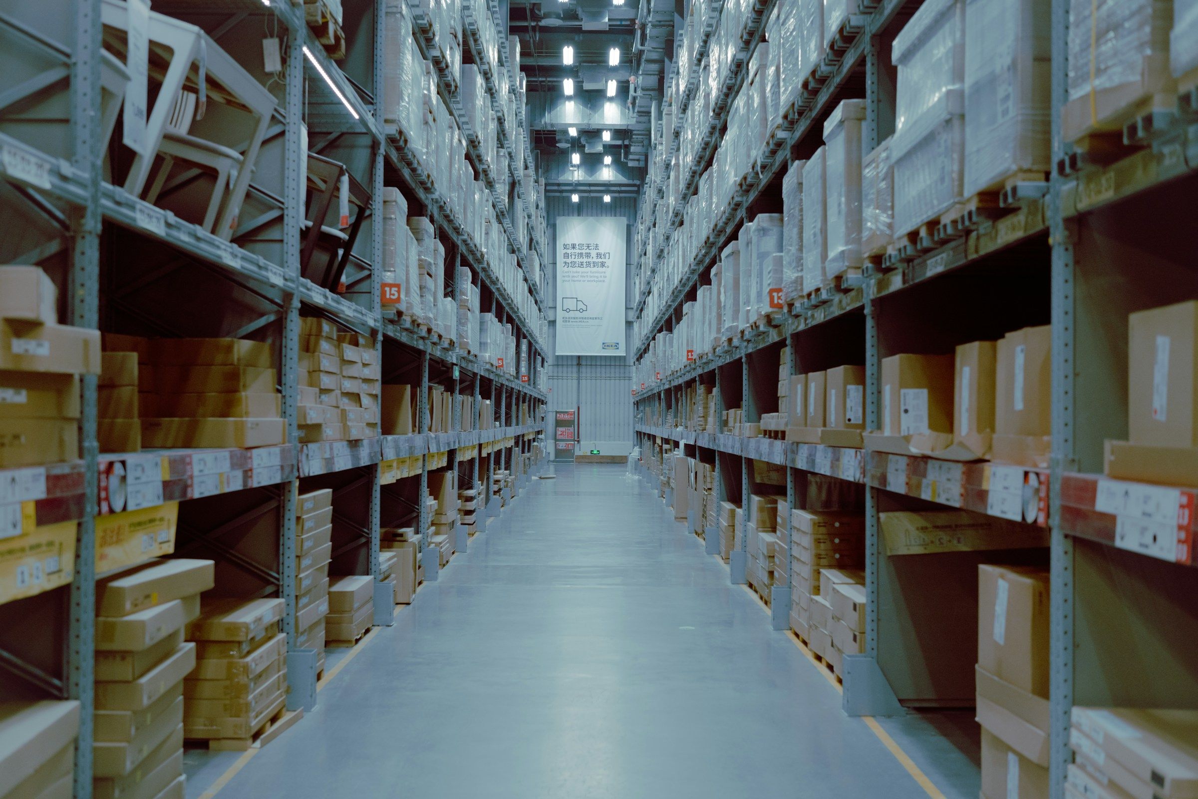 Long warehouse aisle with stocked racking on both sides